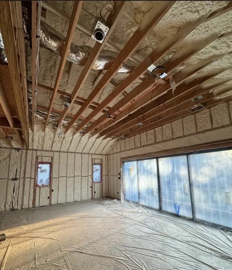Interior walls and ceiling insulated with spray foam during new construction in Kingston
